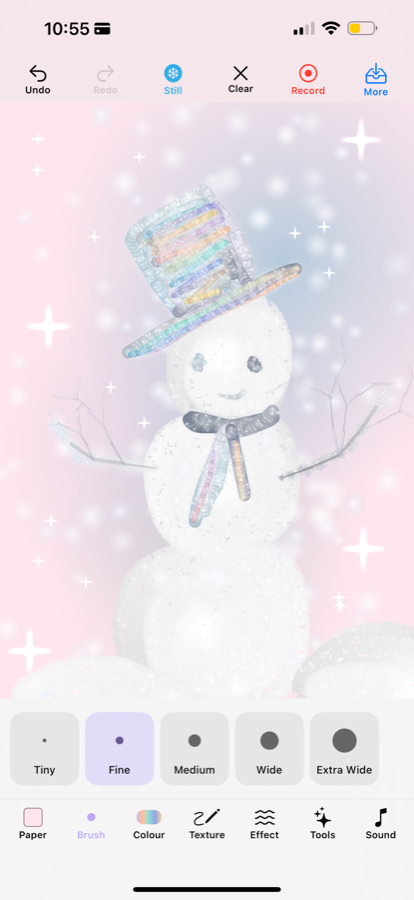 A snowman on pink paper with snow falling in front of the drawing
